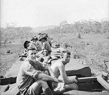 Soldiers ride on the roof of a troop train