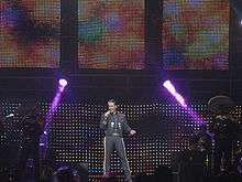 A man singing in a concert.