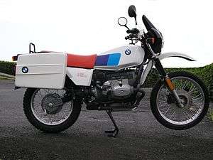 Black BMW R80G/S pictured on gravel at the edge of a lake