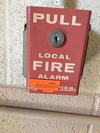 A Notifier pull station at Oklahoma State University. The orange sticker on it warns would-be pranksters the consequences for false alarms.
