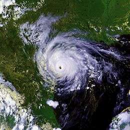 A mature hurricane with a well-defined, cloud free eye over southern Texas. The Gulf of Mexico can easily be seen to the right of the storm and Mexico to the left. Parts of the southern United States are also in the top of the image.