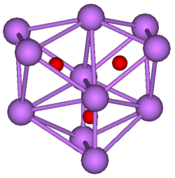 The stick and ball diagram shows three regular octahedra, which are connected to the next one by one surface and the last one shares one surface with the first. All three have one edge in common. All eleven vertices are purple spheres representing caesium, and at the center of each octahedron is a small red sphere representing oxygen.