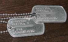 two metal US Army dog tags with Atheist/FSM stamped on them.