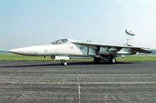 Jet aircraft with pointed nose parked on ramp.