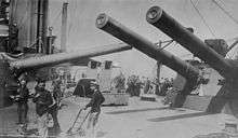 The crowded midships area of dominated by the masses of the 12-inch guns of 'P' and 'Q' turrets, each of which is trained across the deck.