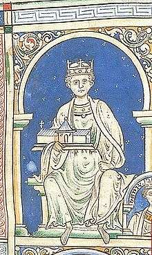 An image of King Henry II, portraying him in all white on a blue background. King Henry is sitting, holding a church. He has a royal crown on his head.