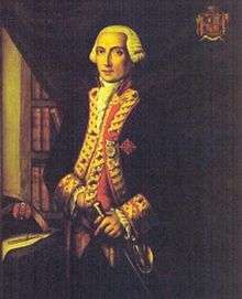 A three quarter length portrait of Admiral Langara, painted when he was younger. He stands before a dark curtain partially pulled aside, revealing a bookcase. His left hand rests on his sword. His coat is a dark color with gold braiding on the lapels, and a red waistcoat is visible underneath.