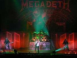A four-piece band performing onstage
