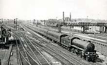 In the centre is a steam locomotove with a trail of carriages. Around the sides, several points allow for easy access to the different routes.