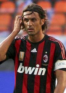 A man a red and black striped top.