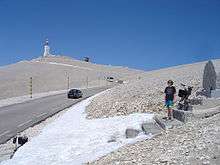Young cyclist on steps of mountain memorial