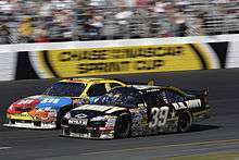 Ryan Newman edges his car past Kyle Busch during the race
