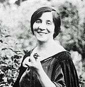 head and shoulders portrait of smiling middle-aged woman