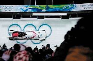 Sled in action during a sports event at night.